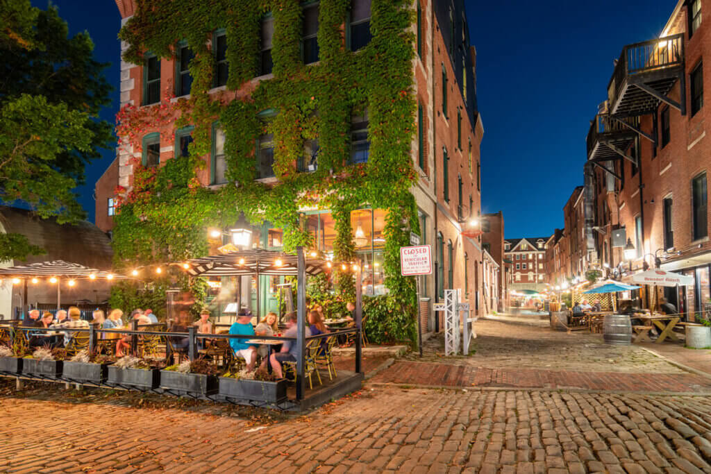 People dine in the Old Port district in downtown Portland, Maine, USA, at night. Credit: iStock