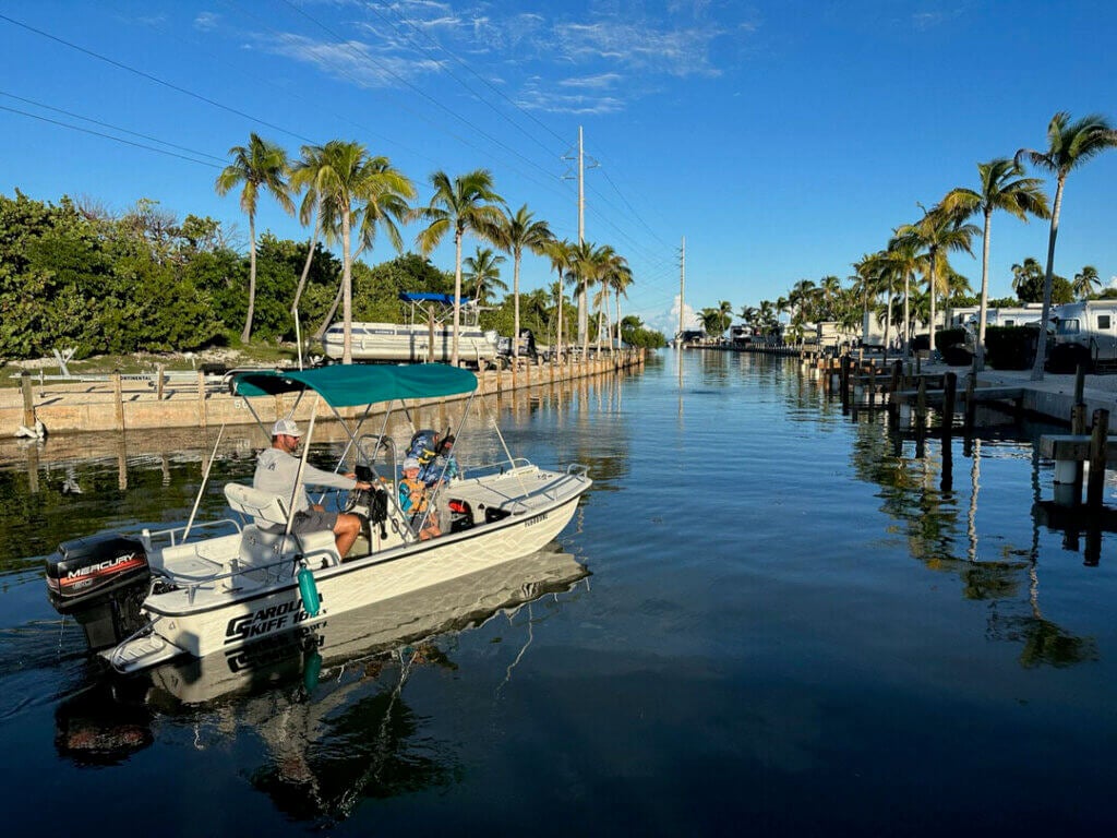 Boat cruising down the canal at Big Pine Key RV Park in Florida.