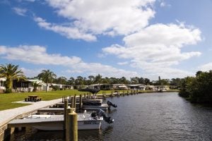 A river surrounded by boats, houses, and trees