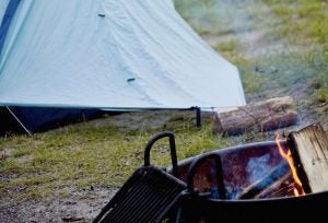 Campfire with tent in background