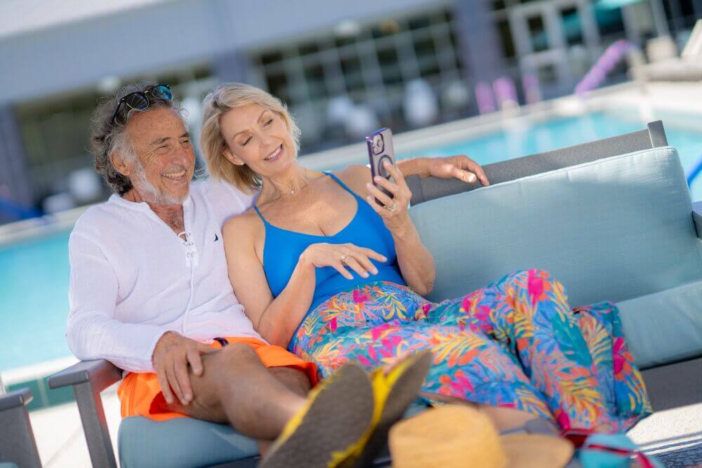A couple sitting by the swimming pool at Rolling Greens Village in Ocala, Florida.