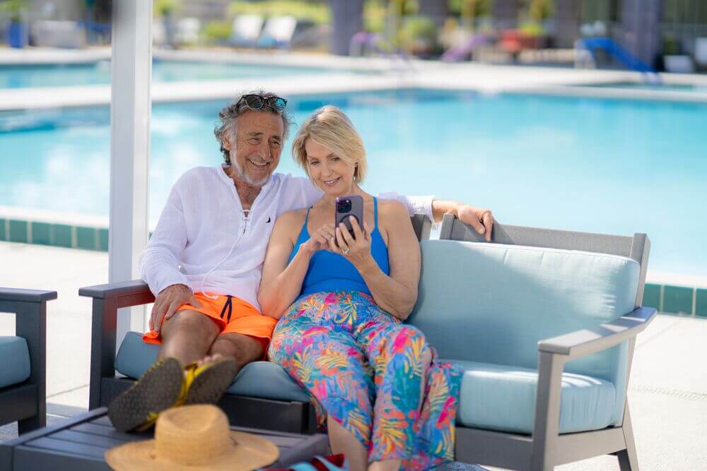 A couple sitting by the swimming pool at Rolling Greens Village in Ocala, Florida.