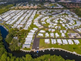 Aerial view of housing community with a river running in front of it