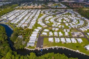 Aerial view of housing community with a river running in front of it