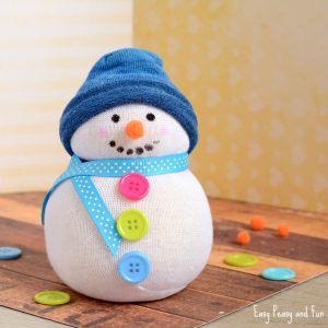 White sock snowman with colorful buttons, blue hat, and blue scarf