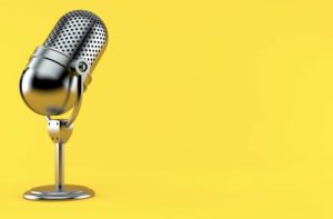 Silver microphone with yellow background