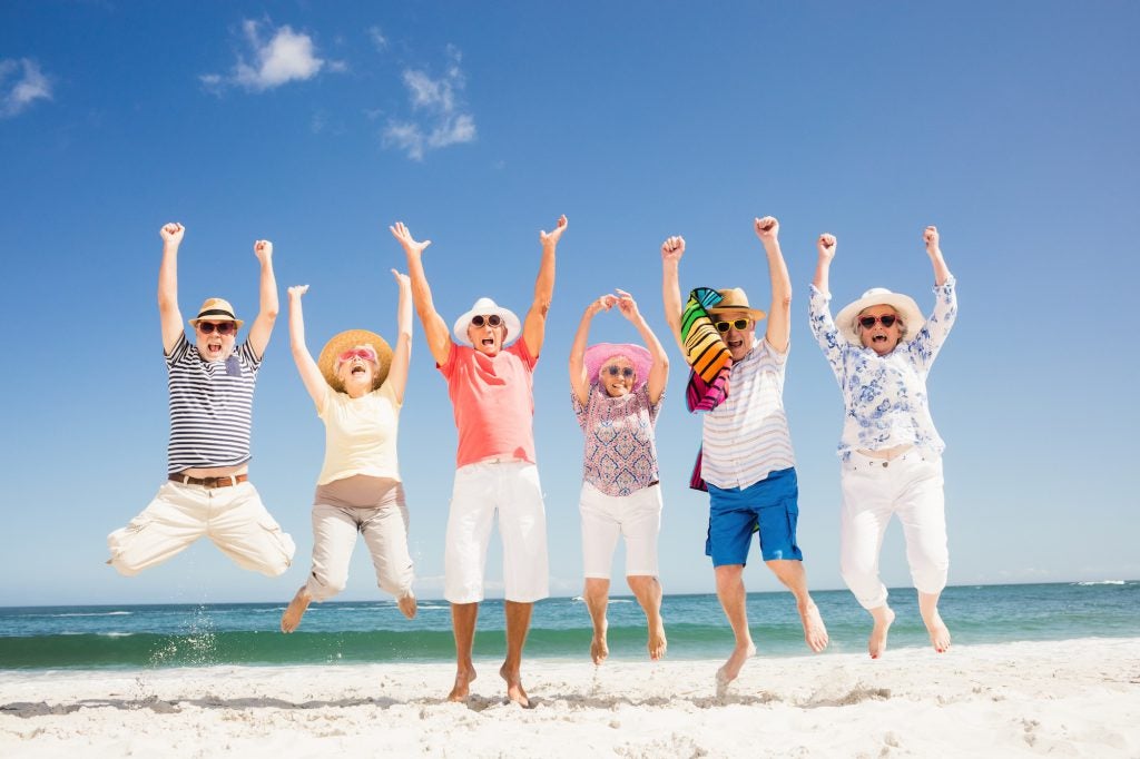 Group jumps for joy on the beach in Florida