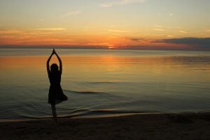 Person stretching on the beach