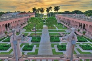 Museum grounds with green trees, grass, and two statues