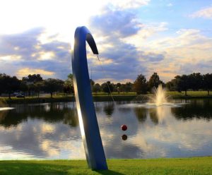 Park with water, fountain, trees, and a sculpture