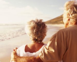 Couple looking out at the sunset over the beach