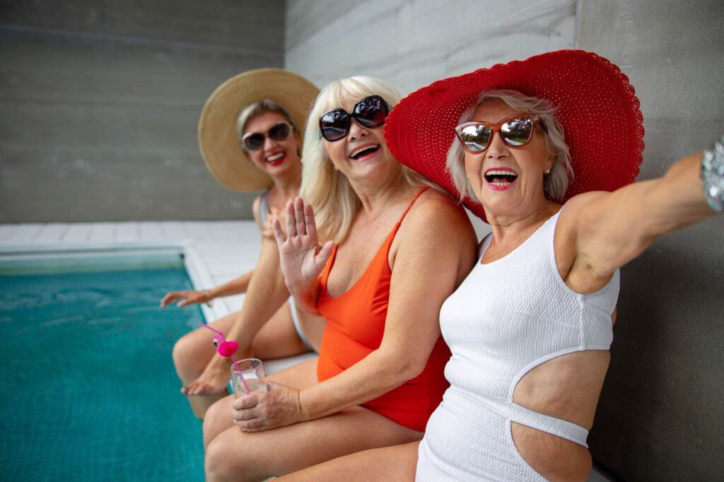 Friends sitting poolside at a Florida retirement community