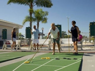 Couple playing shuffleboard at The Meadows, a 55+ community in Florida.