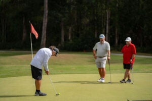 Cypress Lakes Village - golfers putting on course