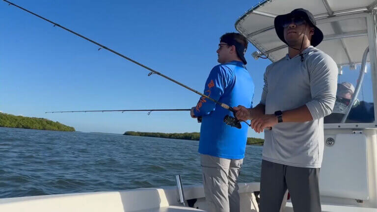 Two men fishing on a boat off the coast of Chokoloskee Island in Florida.