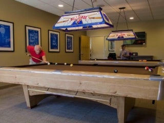 Pool tables in their game room at Camelot Lakes Village