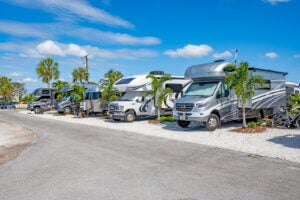 Exterior view of a line of RV's parked in Chokoloskee RV Park sites.