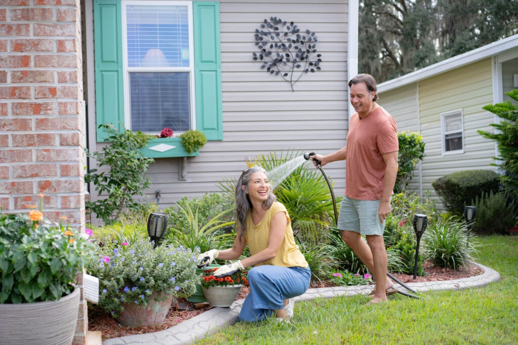 Cypress Lakes Village - couple gardening in front of home