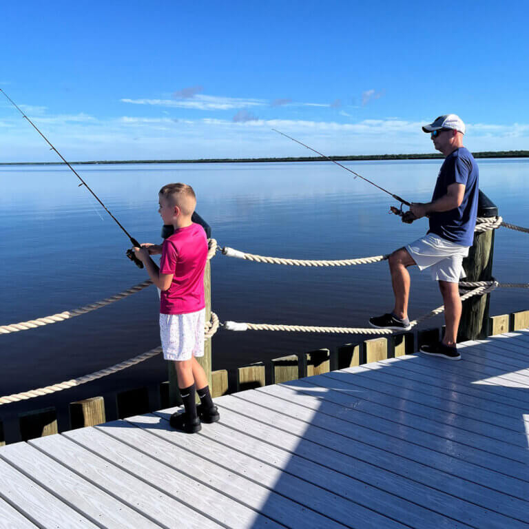 Father and son fishing of the dock at Chokoloskee RV Park in Florida.