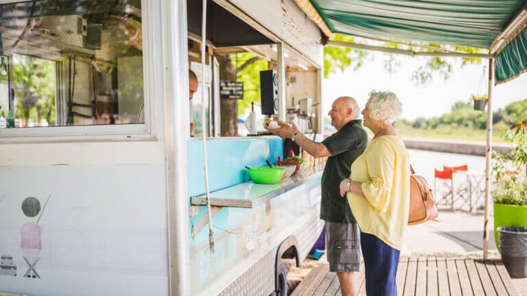 Couple ordering at a food truck.