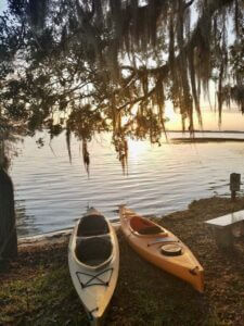 Kayaks sitting by Lake Lowery