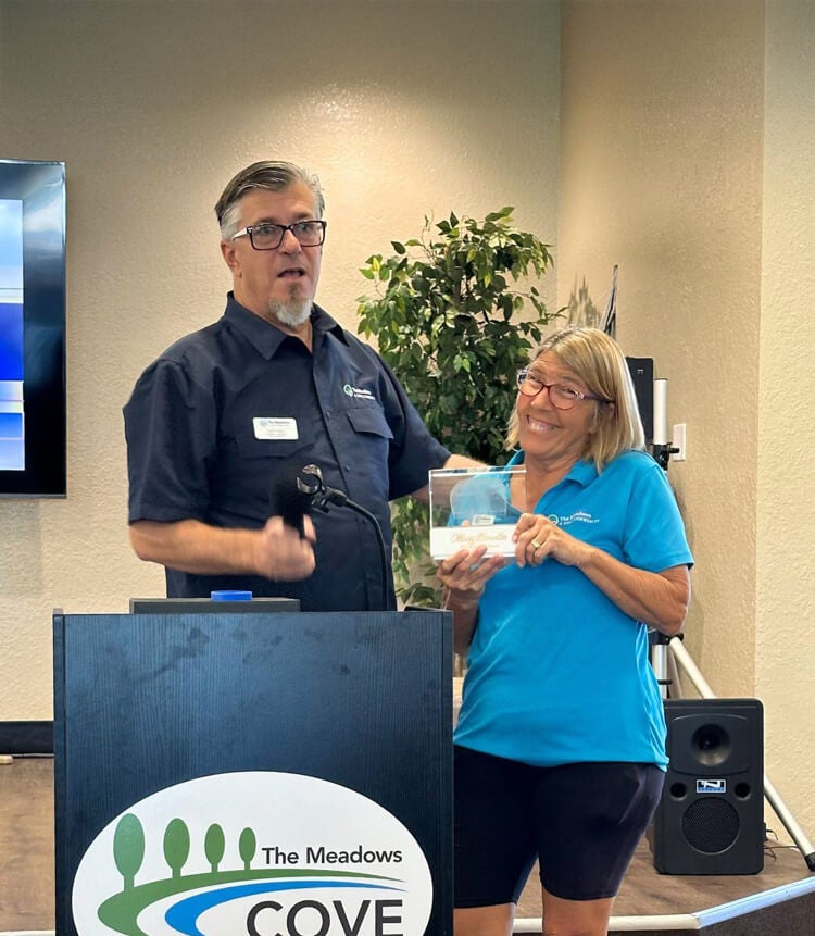 Mary Ann Bonello accepts an award for Cove Communities 2025 Best Team Player at The Meadows in Tarpon Springs, FL.