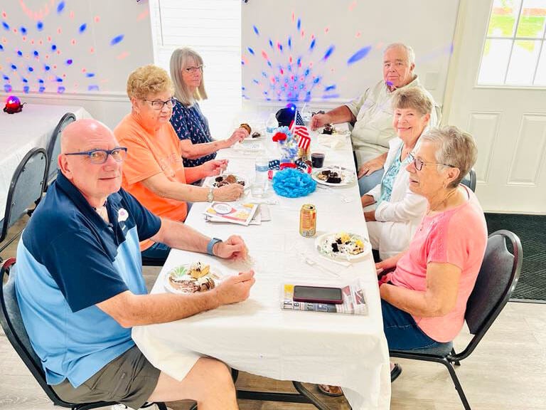 Residents celebrating July birthdays at Meadowlea Village in Florida.