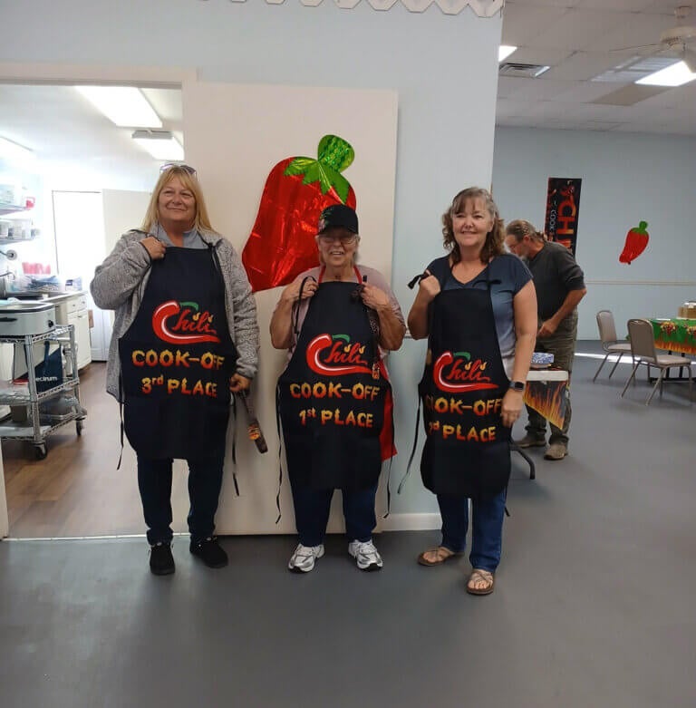 Residents with apron awards from the chili cook-off at oak Harbor RV Park in Haines City, FL.