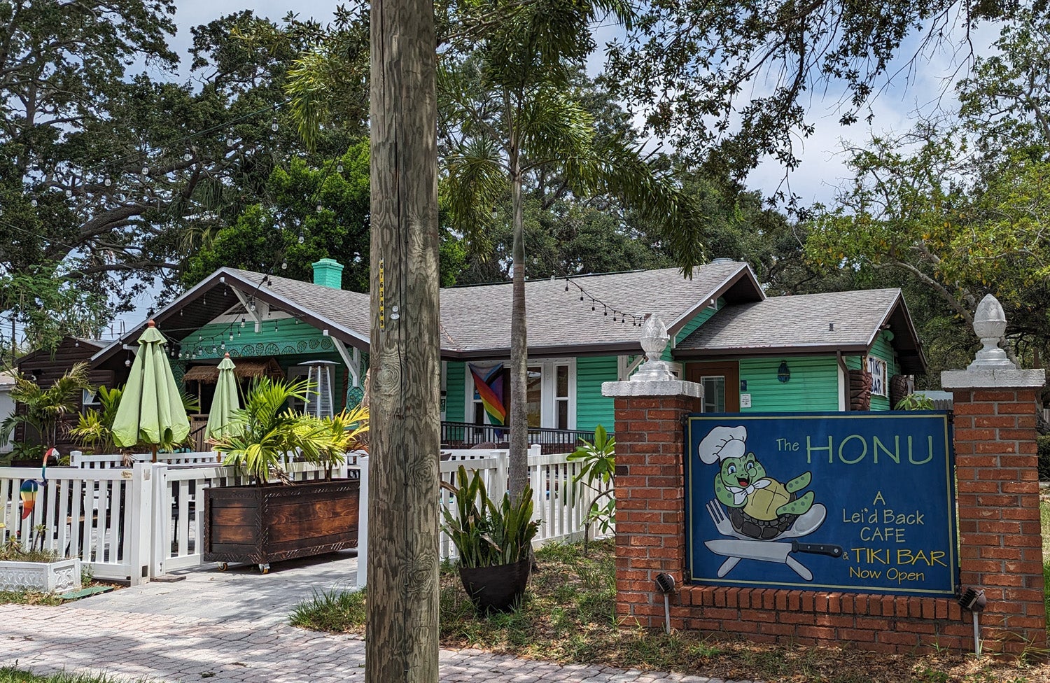 Cafe exterior with sign in foreground