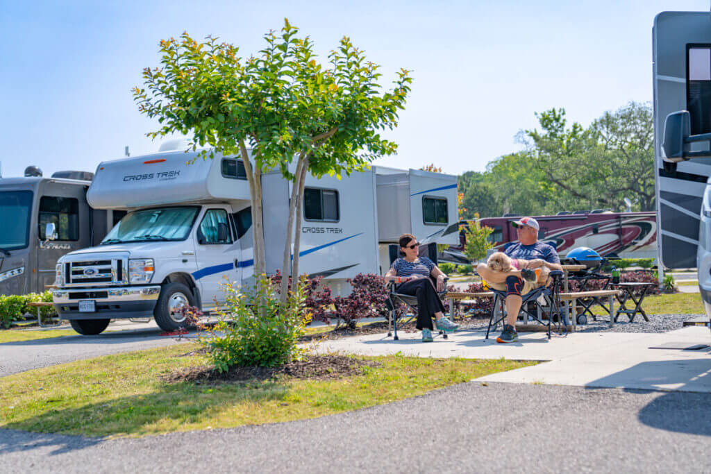 Couple sitting outside their RV at CreekFire RV Resort in Savannah, Georgia.