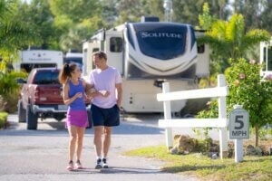 Couple walking away from a fifth wheel trailer at Blueway RV Park in Fort Myers, Florida.