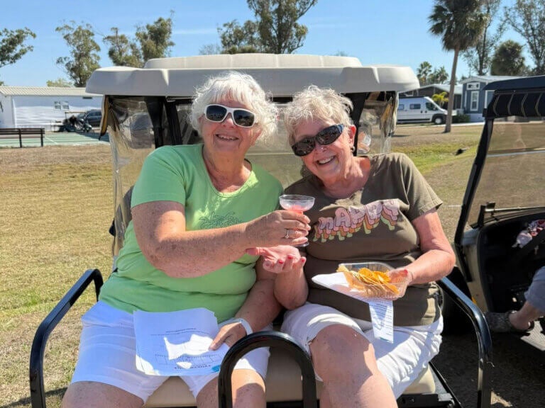 Residents posing on a golf cart at River Vista RV Park in Ruskin, Florida.