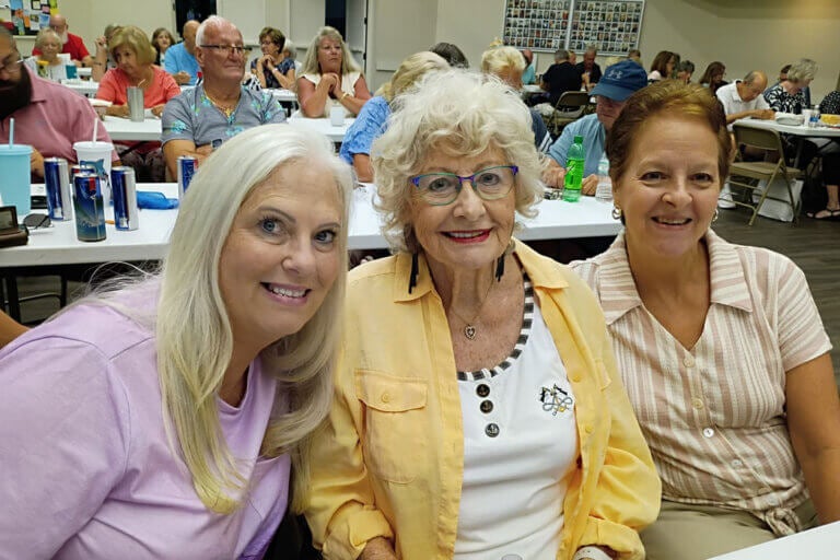 Three woman are an activity at Camelot East Village in Sarasota, Florida.