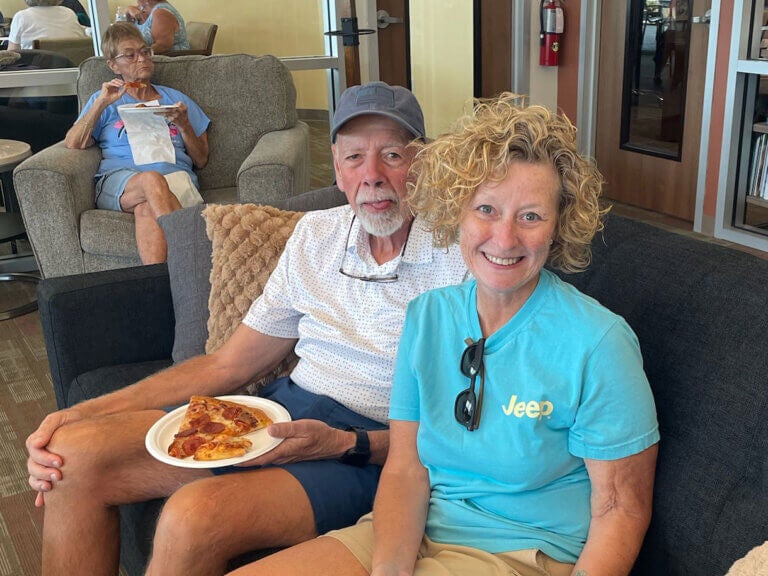 Residents eating pizza at Rolling Greens Village.