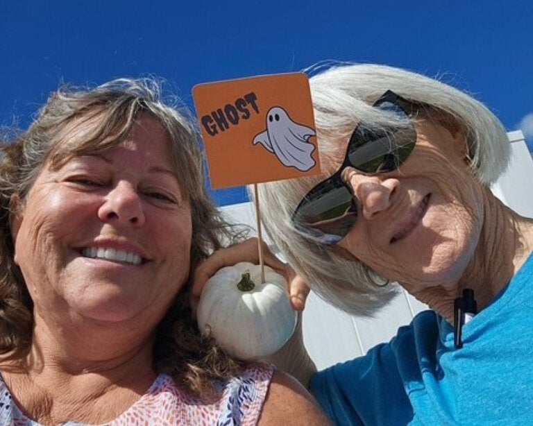 Residents from River Vista RV Park holding a pumpkin.