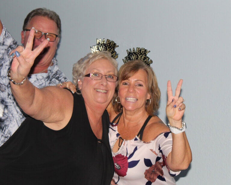 Three residents celebrating New Year's Eve at Rolling Greens Village in Florida.
