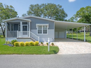 Street view of the front side of a 55+ community manufactured home in Florida.