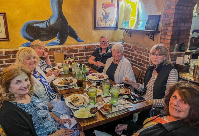 Residents from The Waters, a 55+ Manufactured home community in Melbourne, FL are at a dinner at a local restaurant.