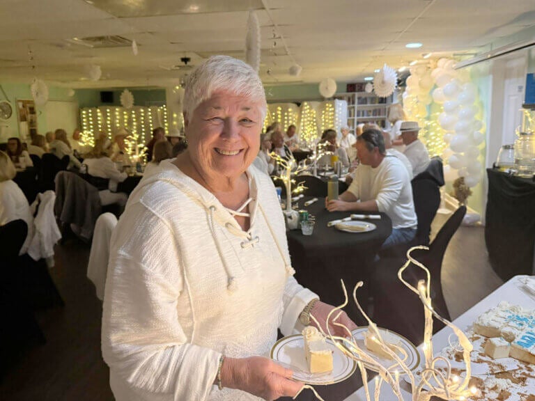 A resident getting food at The White Party 2026 in The Waters.