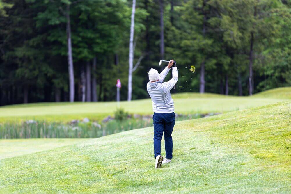 A man in his back swing while golfing at Point Sebago Resort and golf course in Casco, Maine.