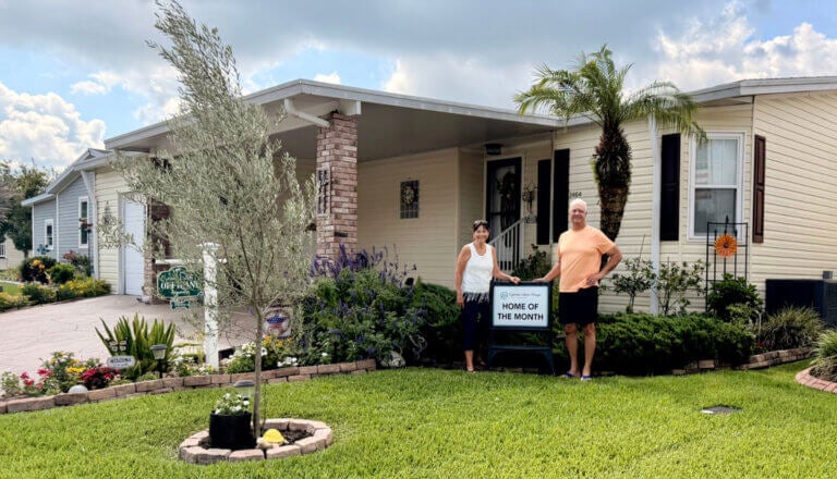 John and Cheryl Offidani in front of their Cypress Lakes Village home.
