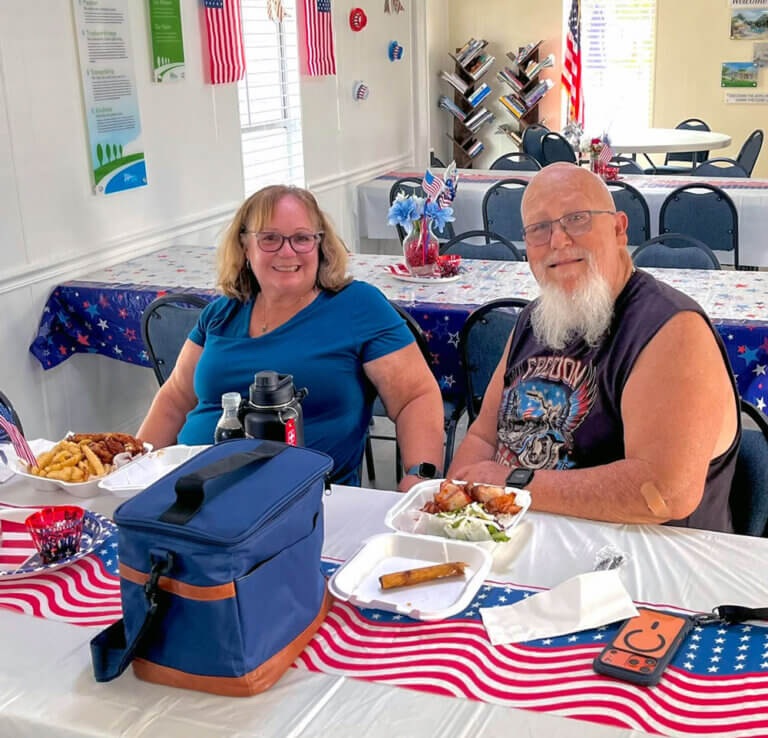 Residents enjoying a meal from the September food truck event at Meadowlea Village in DeLand, Florida