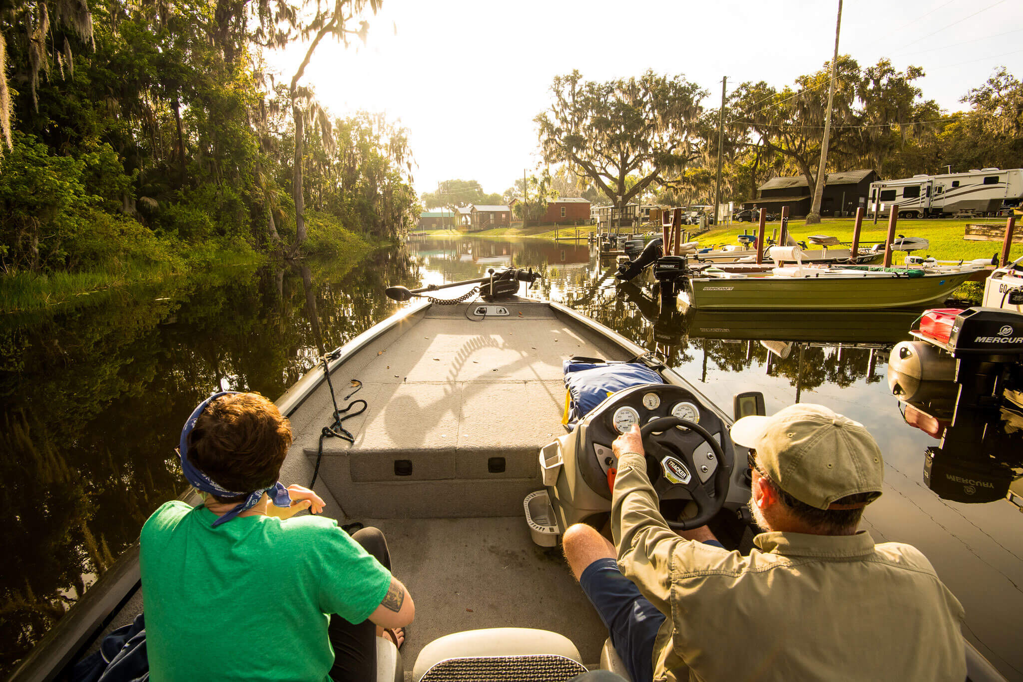 Two guys riding in boat down canal at Oak Harbor