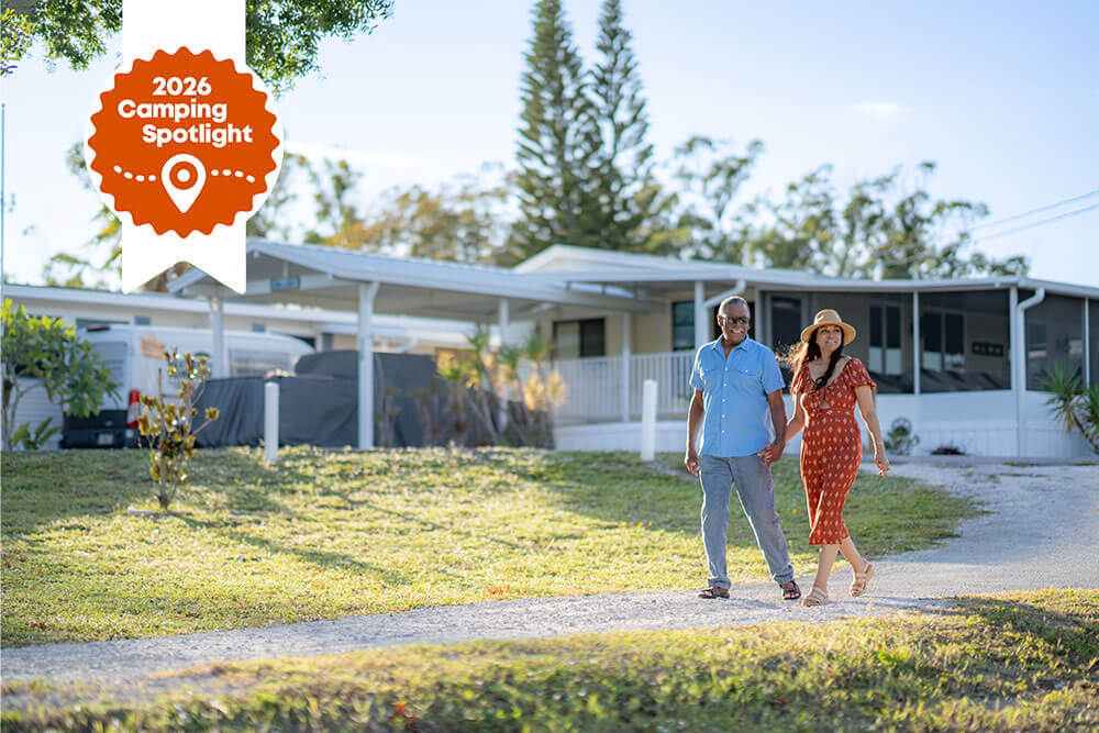 spot-2-nite-river-vista-rv-park Camping Spotlight award for River Vista RV Park by Spot2Nite over an image of a couple walking through the community.