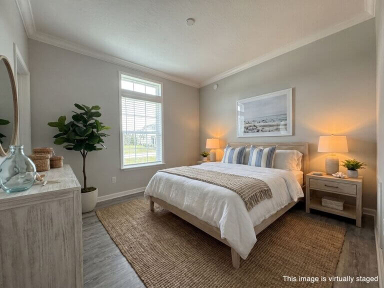 Virtually staged bedroom with furniture within a manufactured home at Estero Bay Village in Florida.