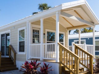 Side view of front porch of a Park Model Cottage For Sale in 2023-24