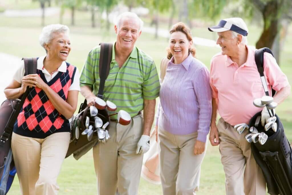 Portrait Of Four Friends Enjoying A Game Golf