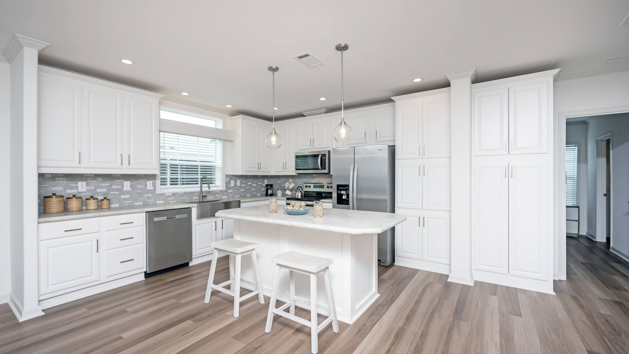 Wide view of kitchen and island in Jamaica Bay Village in Fort Myers, Florida.