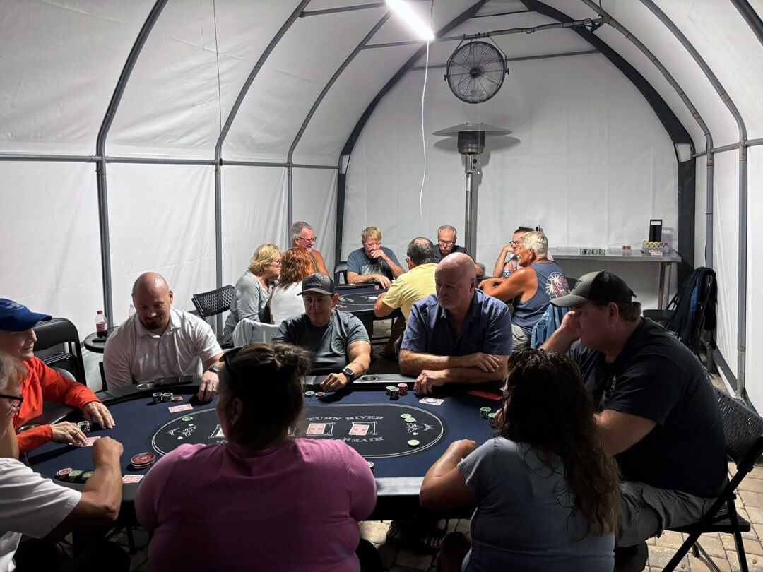 people sitting around two card tables playing poker