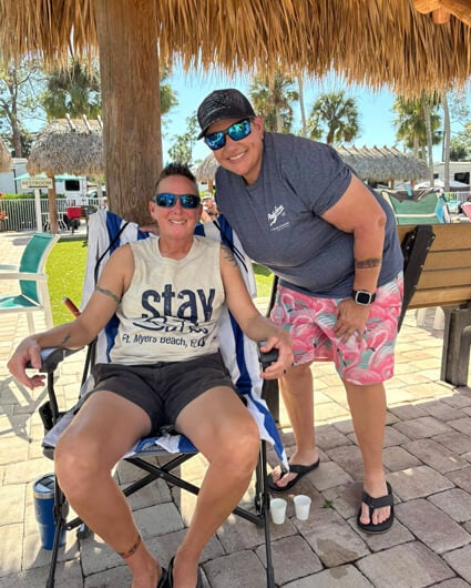 Guests in the tiki hut by the community pool at Blueway RV Park in Fort Myers, Florida.